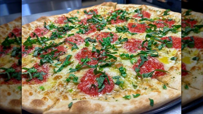 New York-style pizza with cheese and greens