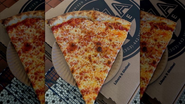 Slice of pizza on a plate on a pizza box
