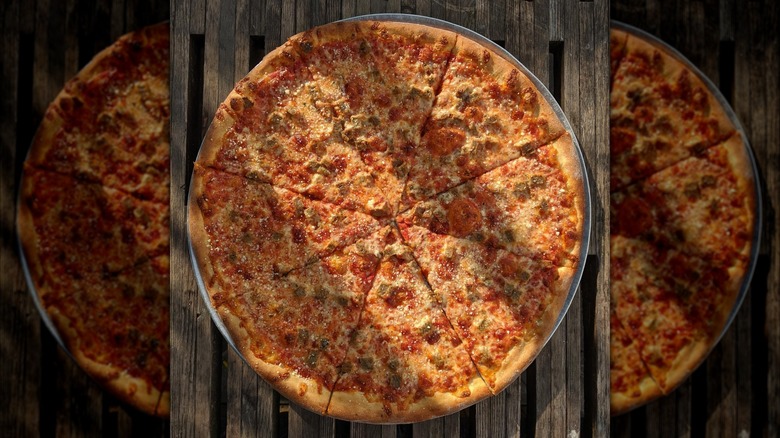 Thin crust pizza from above on wooden background