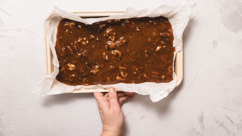 Hand holding pan with candy mixture