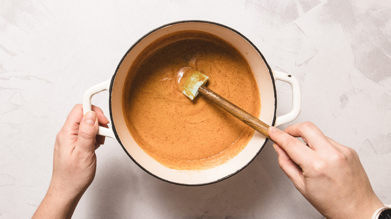 Stirring candy mixture in white pot