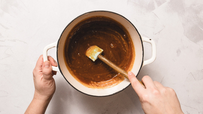 Stirring candy mixture in white pot