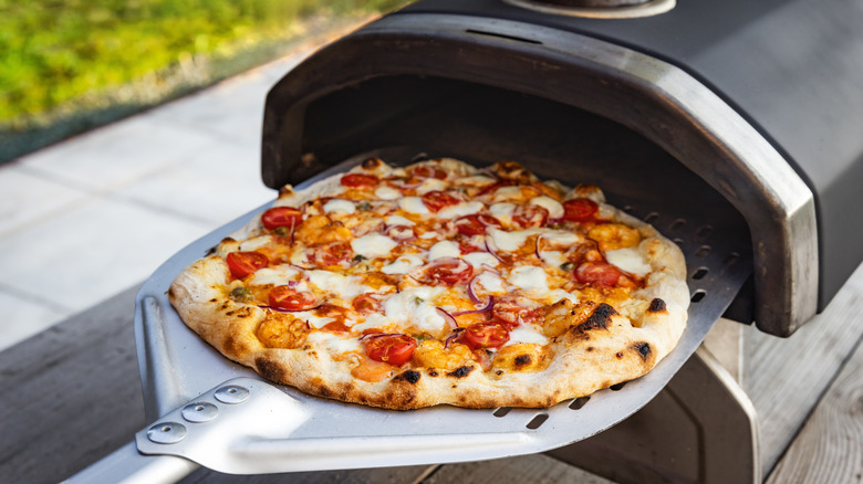 cooking in an outdoor pizza oven