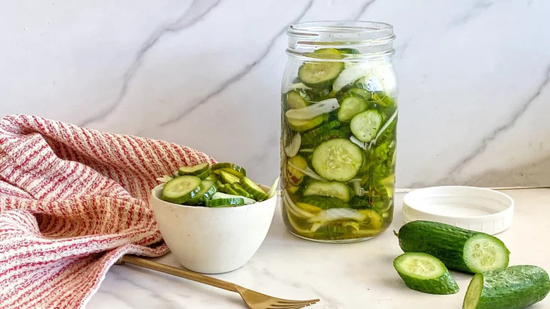 Classic Bread and Butter Pickles in jar and white bowl