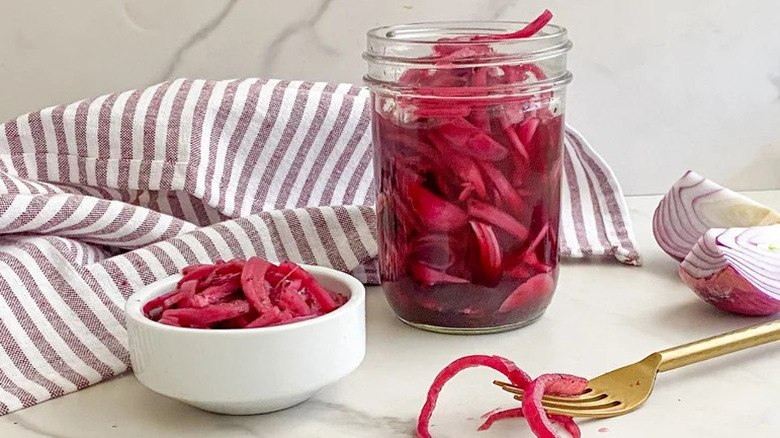 Sugar-Free Pickled Red Onions in glass jar and white bowl