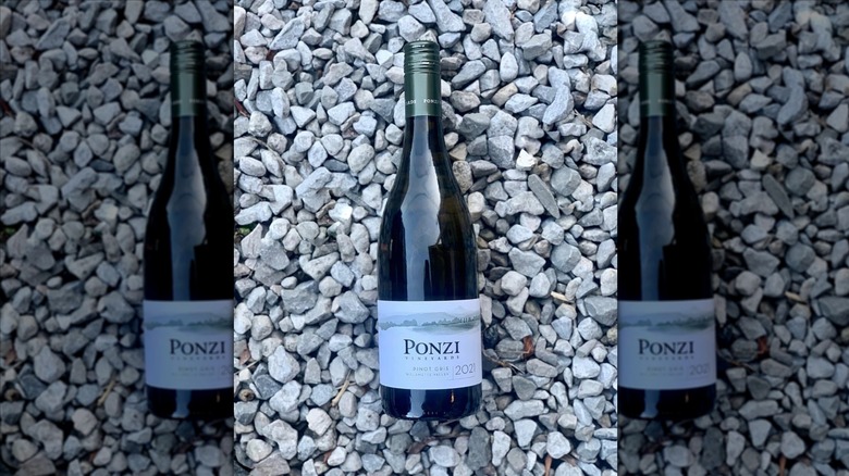 Bottle of Ponzi Pinot Gris laying on gray stones