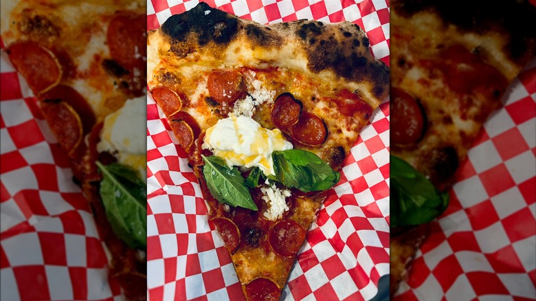 Pepperoni pizza with soft cheese and basil