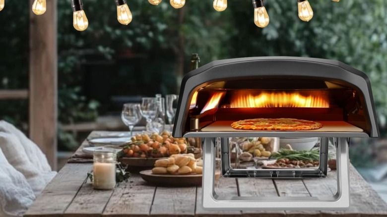 A NutriChef pizza oven on a picnic table