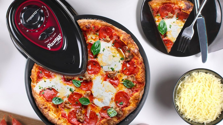 A Presto Pizzazz Plus rotating oven cooking a pizza