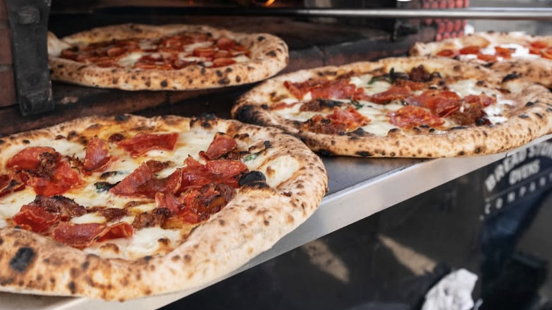 three pizzas being cooked at Cane Rosso