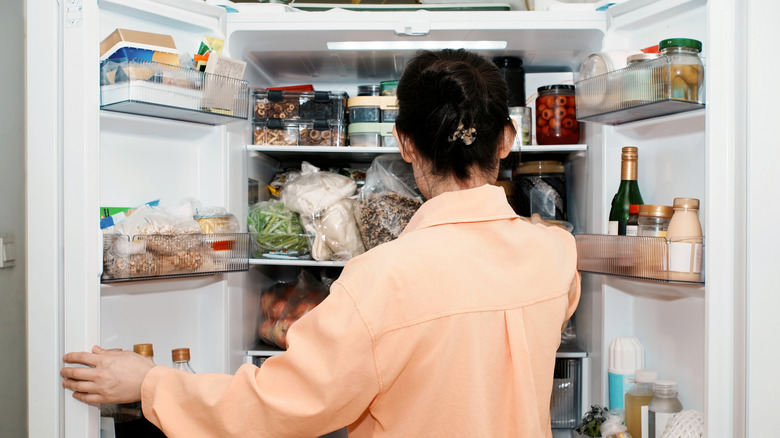 women opening refrigerator