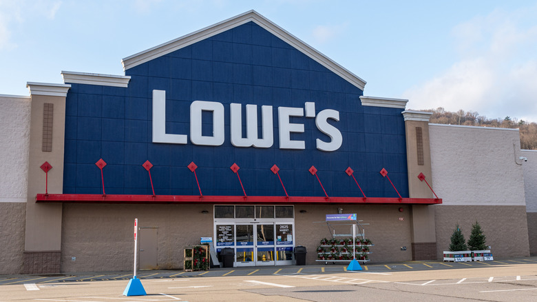 Exterior of Lowe's store with white logo signage on blue storefront with red awning