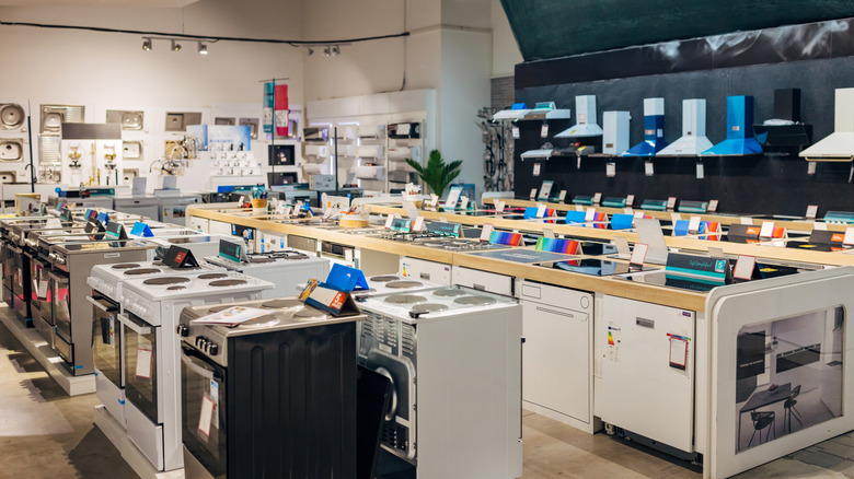 Interior of appliance store with stoves, dishwashers, range hoods, and other kitchen items on display