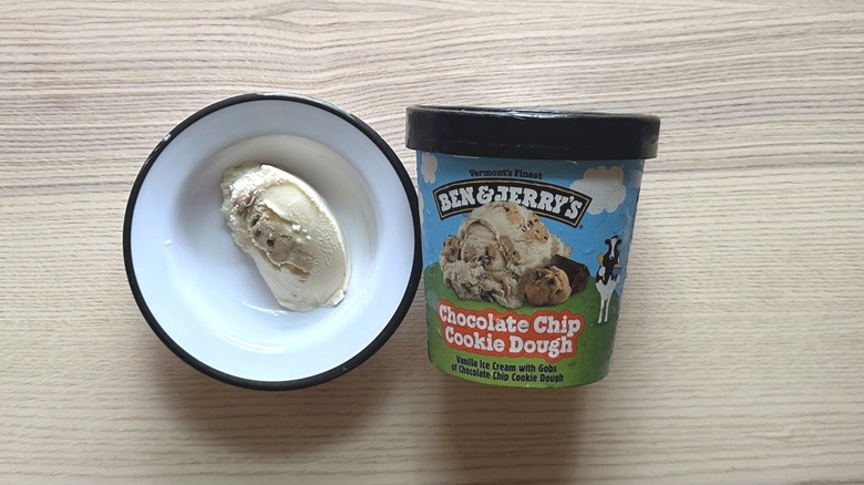 A bowl with a scoop of ice cream next to a pint of Ben & Jerry's