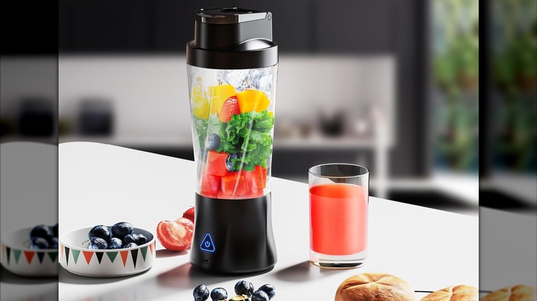 A KPMARE portable blender with fruits and veggies
