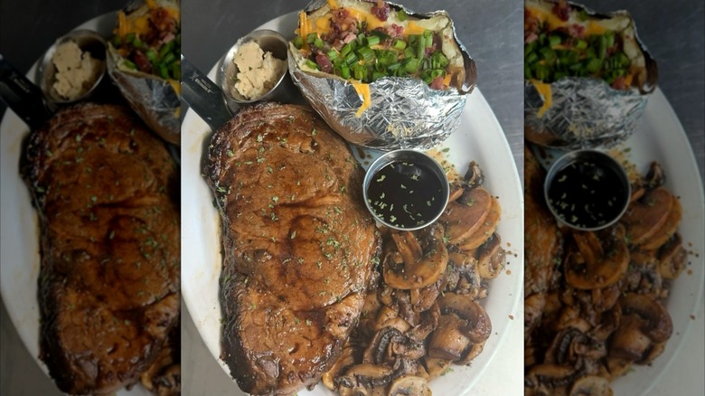 Prime rib with baked potato, mushrooms, au jus