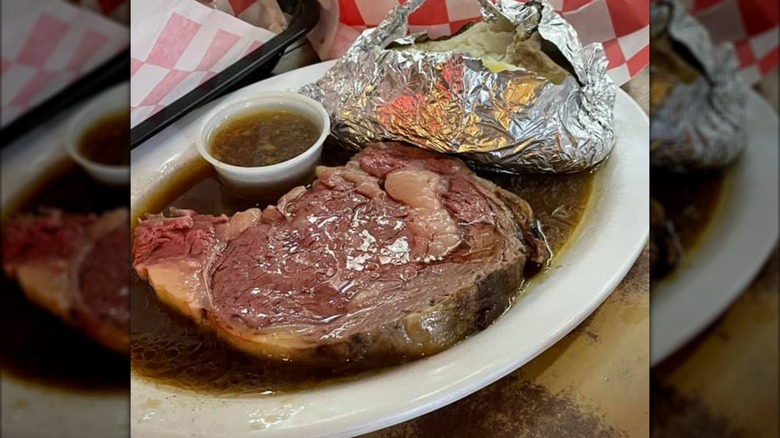 Prime rib and baked potato with au jus