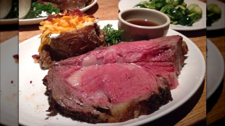Prime rib with baked potato and au jus