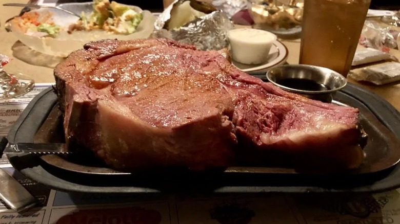 Queen cut prime rib on table with plates in background