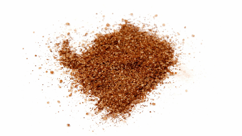 Ground coffee and sugar mixture on a white surface