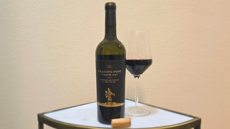 Bottle of Trading Post by TJ's Napa Valley Cabernet Sauvignon and glass