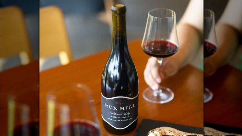 bottle of red wine with glass