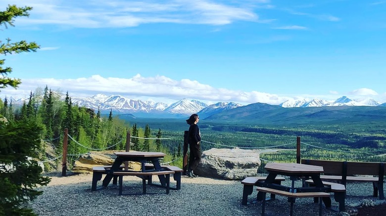 Person standing in the outdoor area at the Alpenglow Restaurant