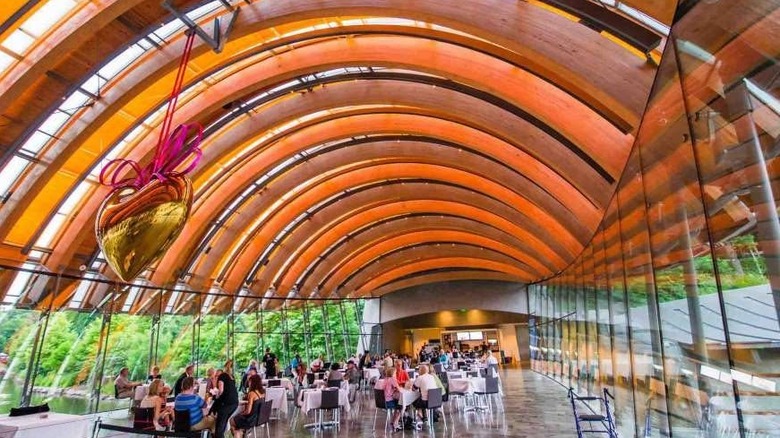 Diners under a large arch at a museum restaurant