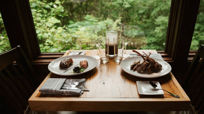 Table at the Greenbrier Restaurant with background views of the forest