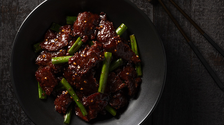 mongolian beef in black bowl