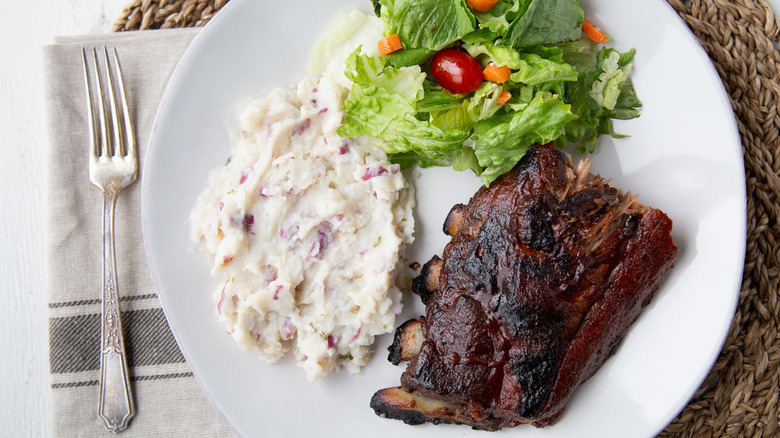Easy Baby Back Ribs with mashed potatoes and salad on white plate