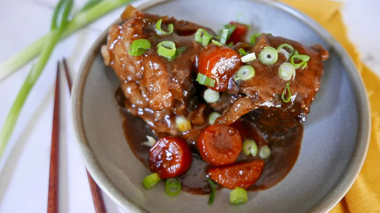 Slow Cooker Korean Short Ribs on grey plate with carrots and green onions