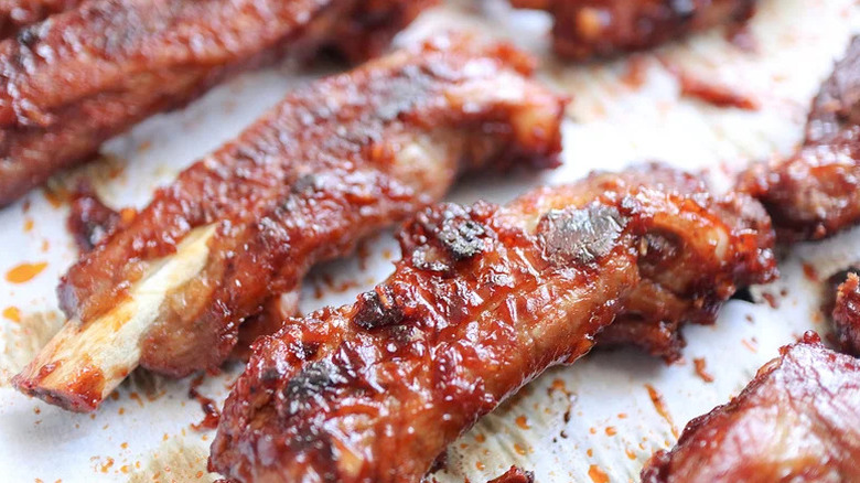 Spicy Oven-Baked Pork Spare Ribs close up on white paper