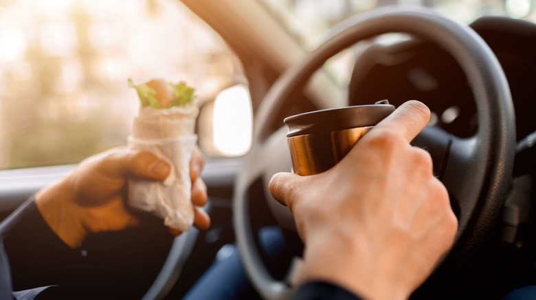 Person driving with snacks