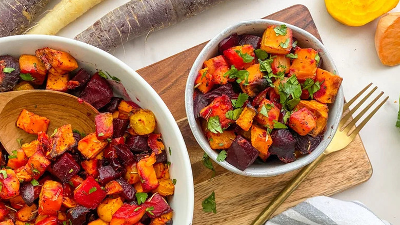 Roasted root vegetables served in two bowls of different sizes and garnished with parsley