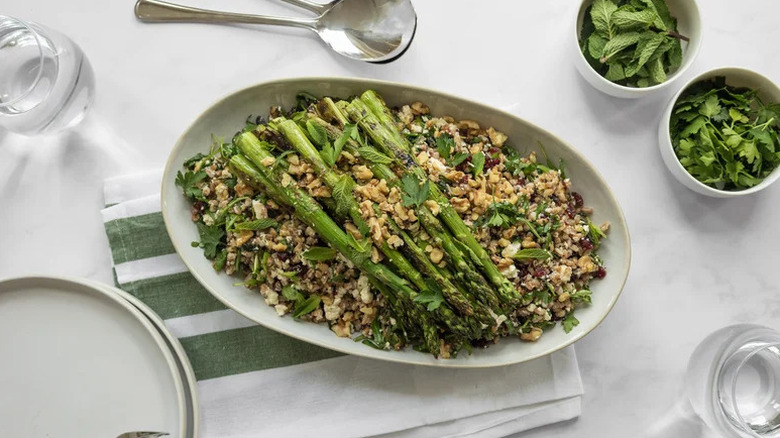 Farro salad with roasted asparagus spears on serving platter