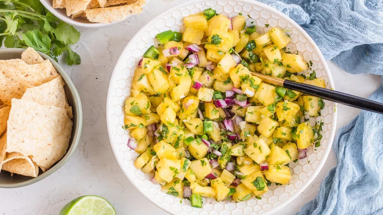 Pineapple Salsa in white bowl with spoon