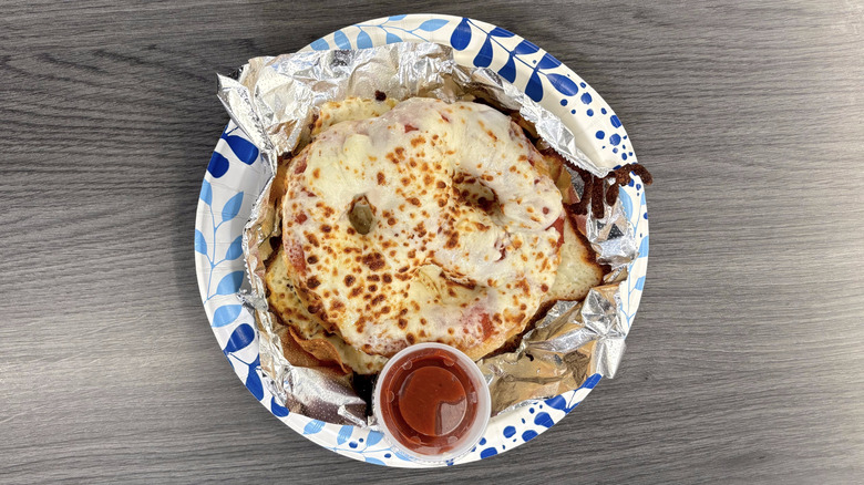 Sam's Club Cafe pizza pretzel on paper plate and cafe table