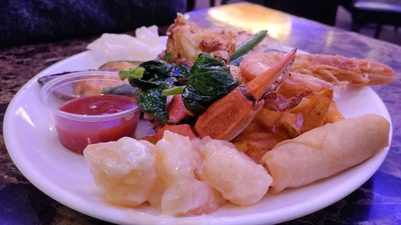 A plate of egg rolls and assorted seafood at Shiki Seafood Buffet