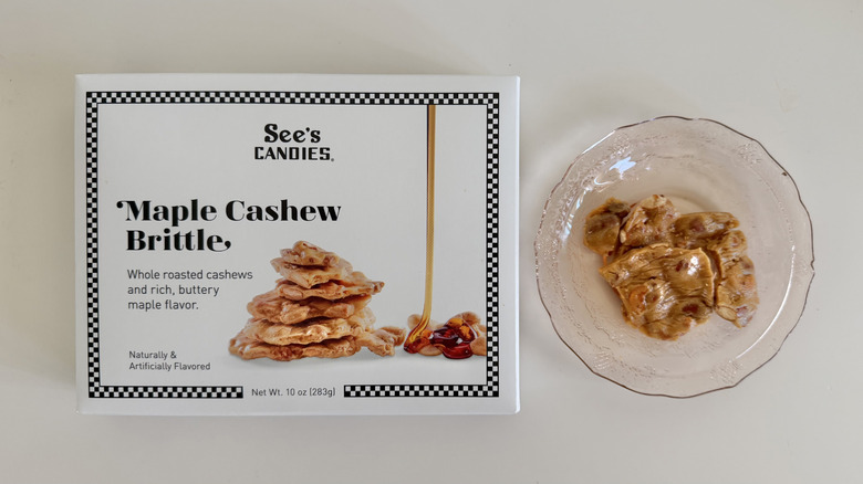 See's Maple Cashew Brittle on a plate next to the product box.