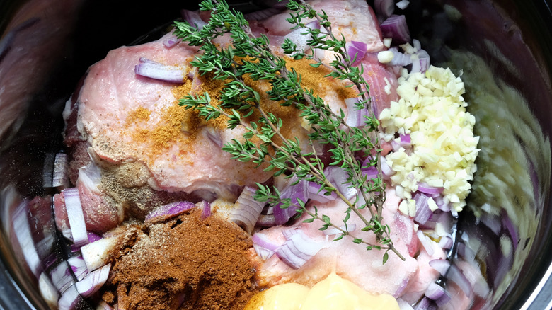 Pulled pork ingredients in slow cooker before being mixed together