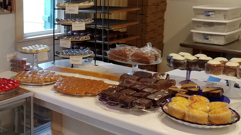The counter inside Jampot with displays of fruit cakes, truffles, brownies, and muffins.