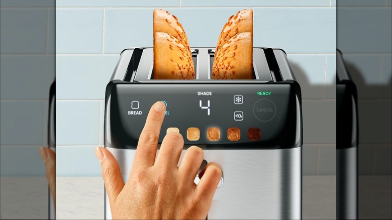 A person setting a Chefman toaster