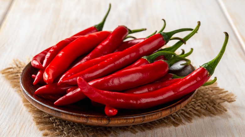 red peppers on a wooden plate