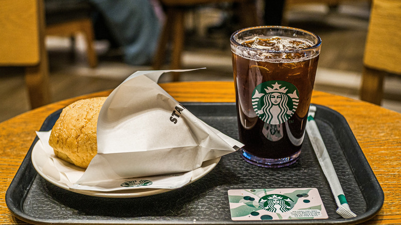 starbucks coffee with breakfast sandwich on tables