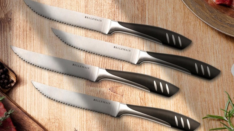 Four Bellemain steak knives on a wooden table
