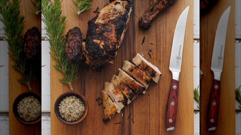 Messermeister steak knife on a platter with meat