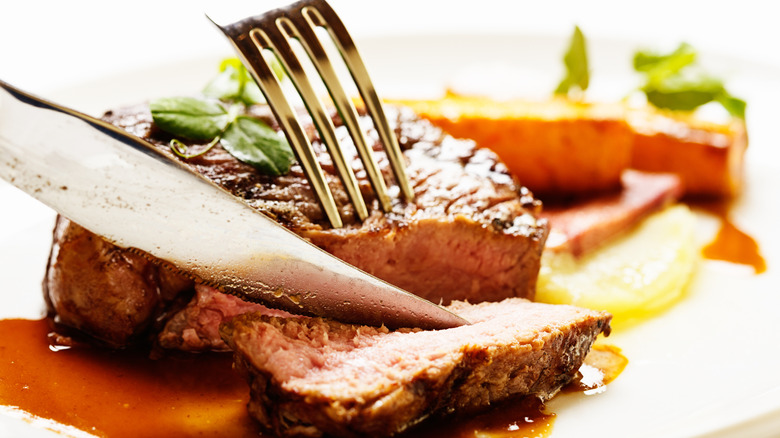 Cutting a steak with a steak knife