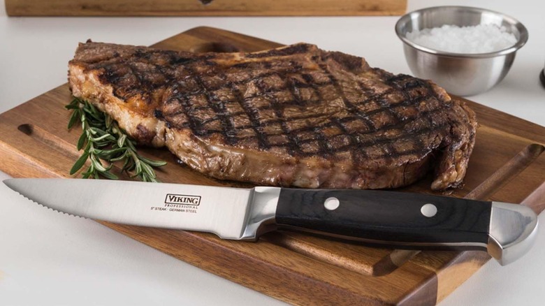 Viking steak knife with a steak on a cutting board