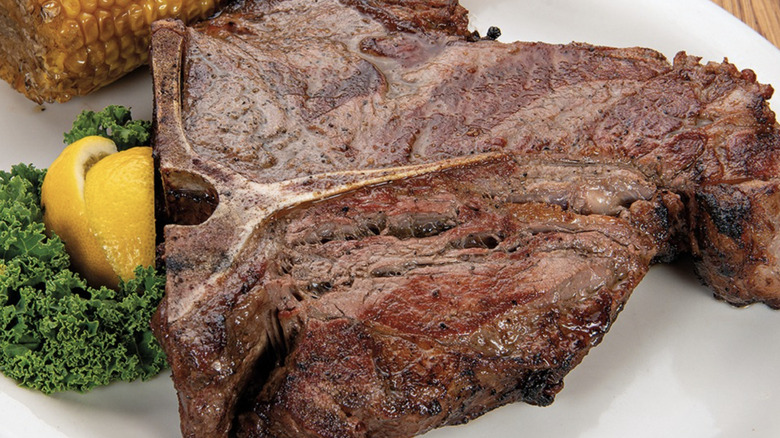 Large steak on plate with garnish